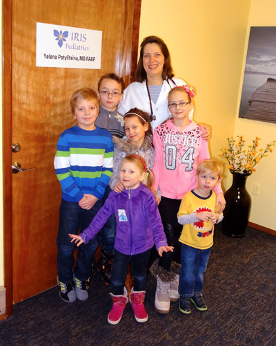 Dr. Yelena Potylitsina and kids outside her pediatric office in Holmdel, NJ